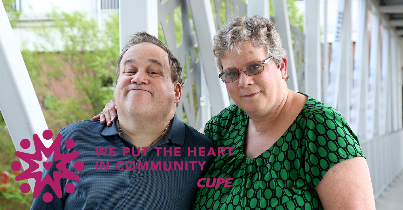 Man with down syndrome outdoors, there is counsellor assisting him.